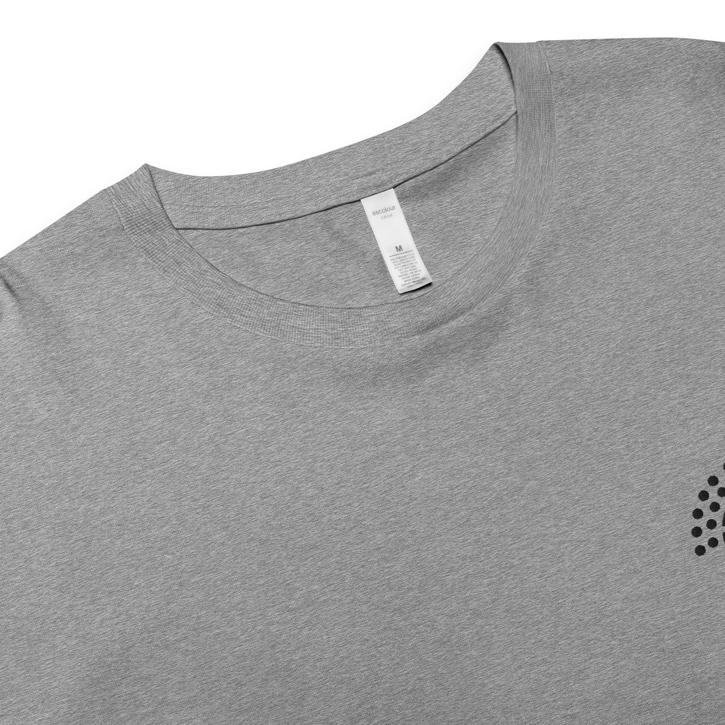 zoomed in image of grey crop top featuring inside label with logo and product details