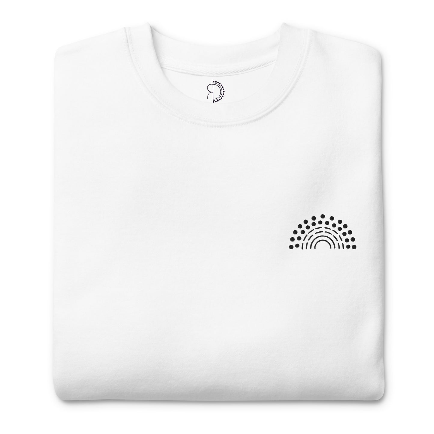 folded white crewneck sweatshirt with black pride rainbow embroidered on the left chest