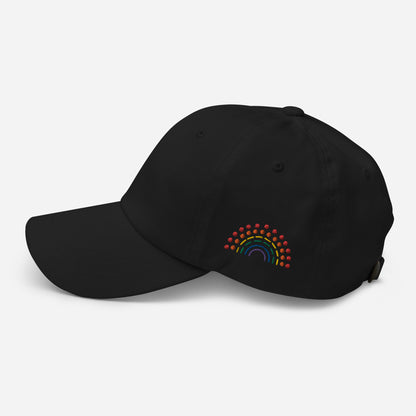 black baseball dad hat with multicolored pride rainbow embroidered on the left of the hat