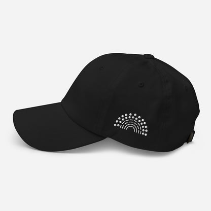 black baseball dad hat with white pride rainbow embroidered on the left of the hat