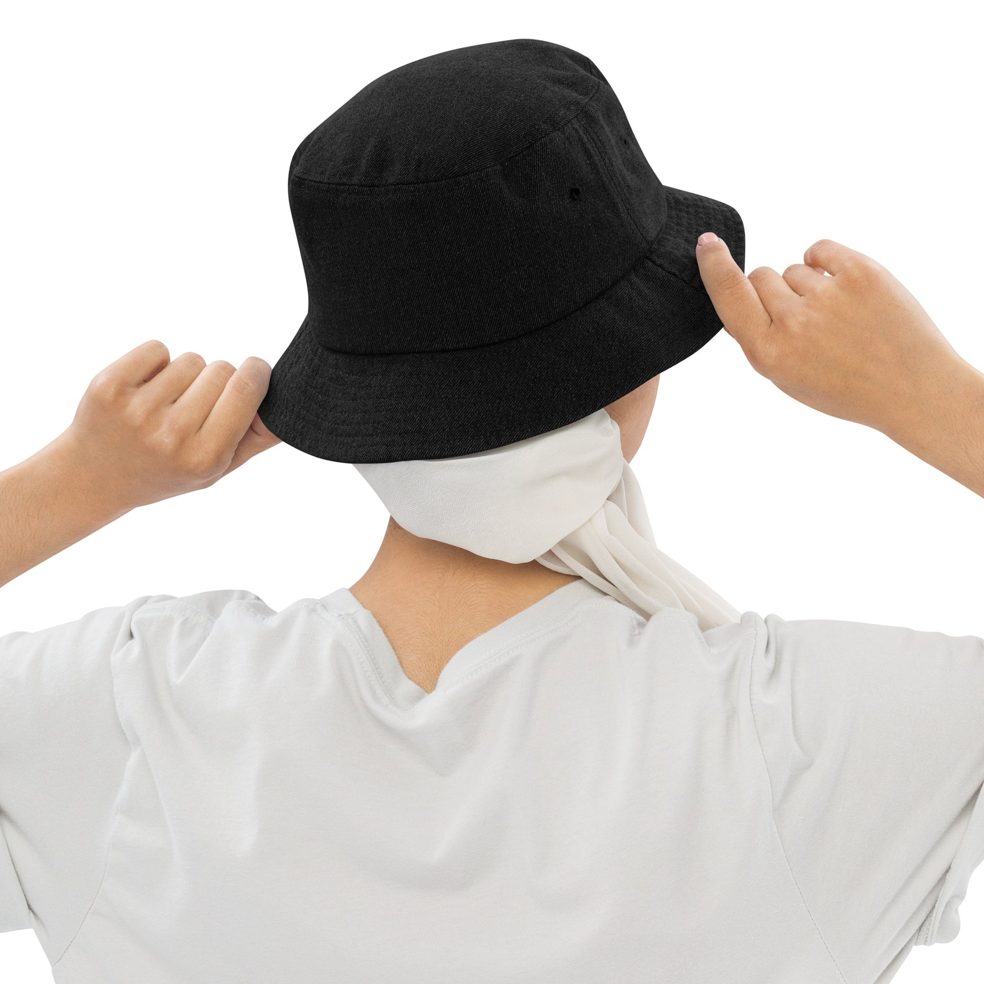 person wearing a black denim bucket hat displaying the back of the hat