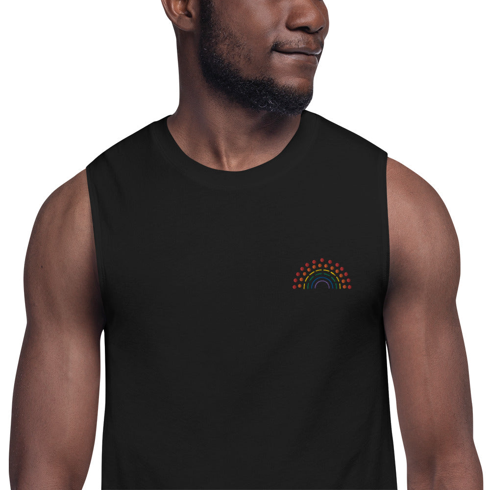 zoomed in image of person wearing a black muscle tank top with multicolored pride rainbow embroidered on the left chest