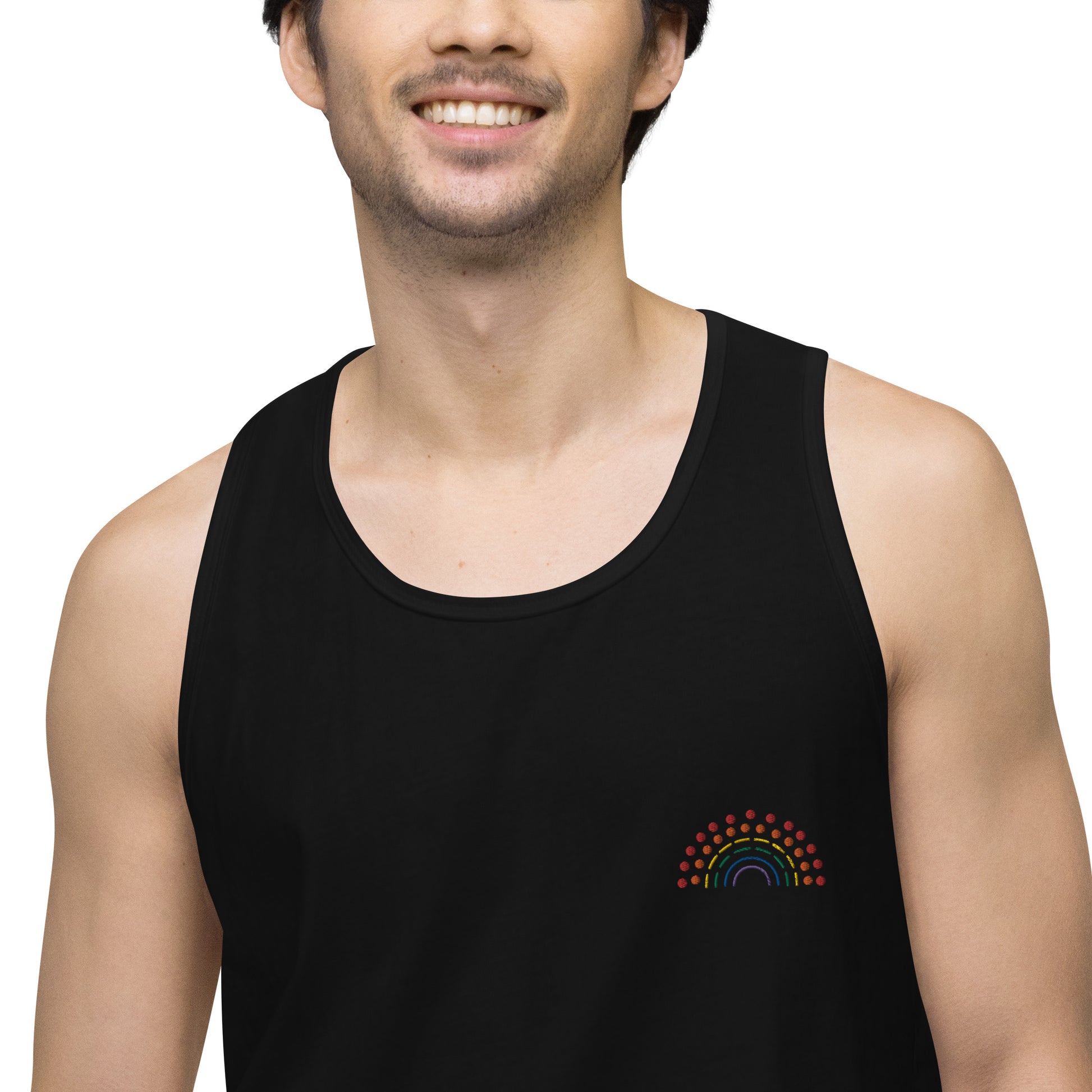 zoomed in image of person wearing a black athletic tank top with multicolored pride rainbow embroidered on the left chest