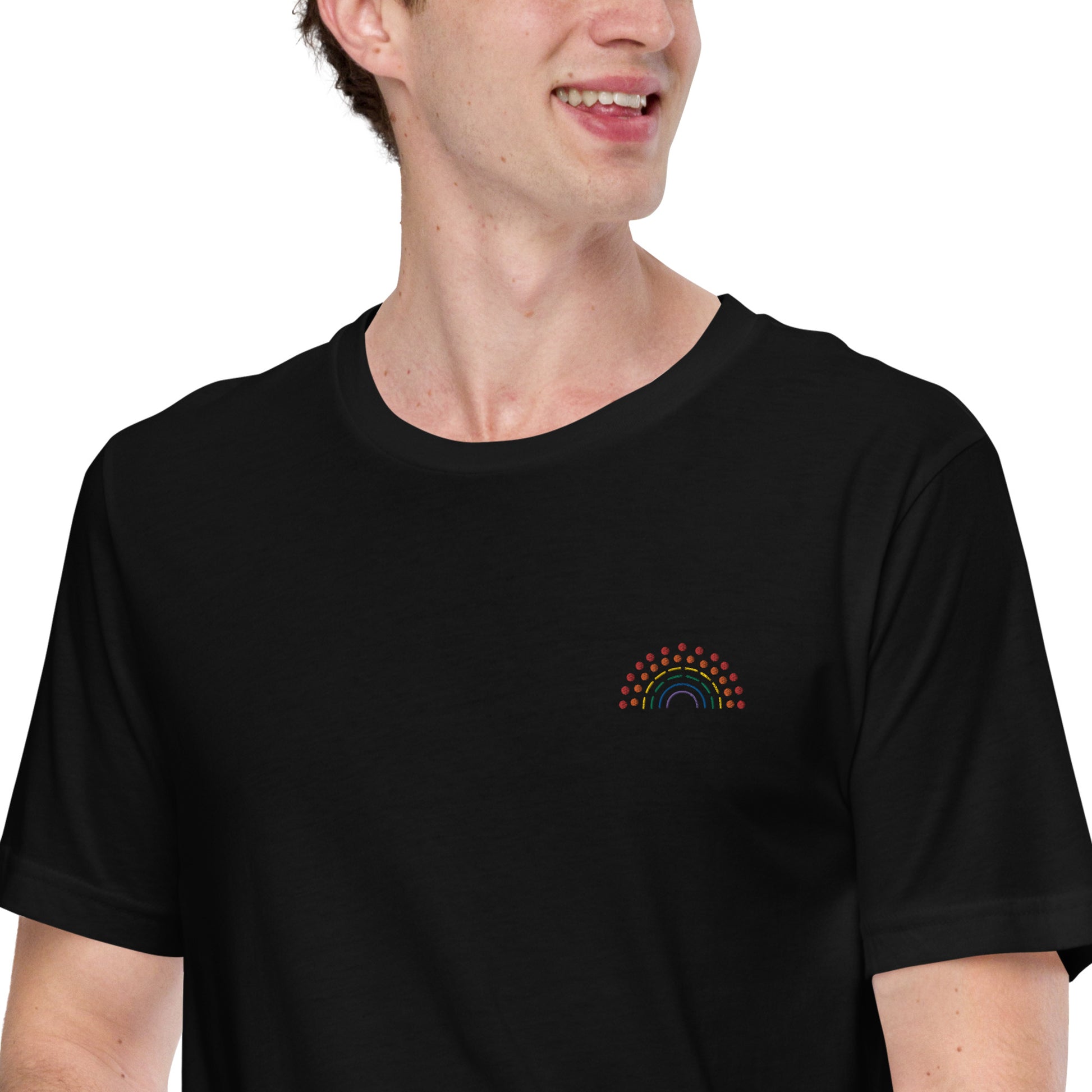 person wearing a black t-shirt with multicolored pride rainbow embroidered on the left chest