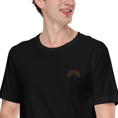 person wearing a black t-shirt with multicolored pride rainbow embroidered on the left chest