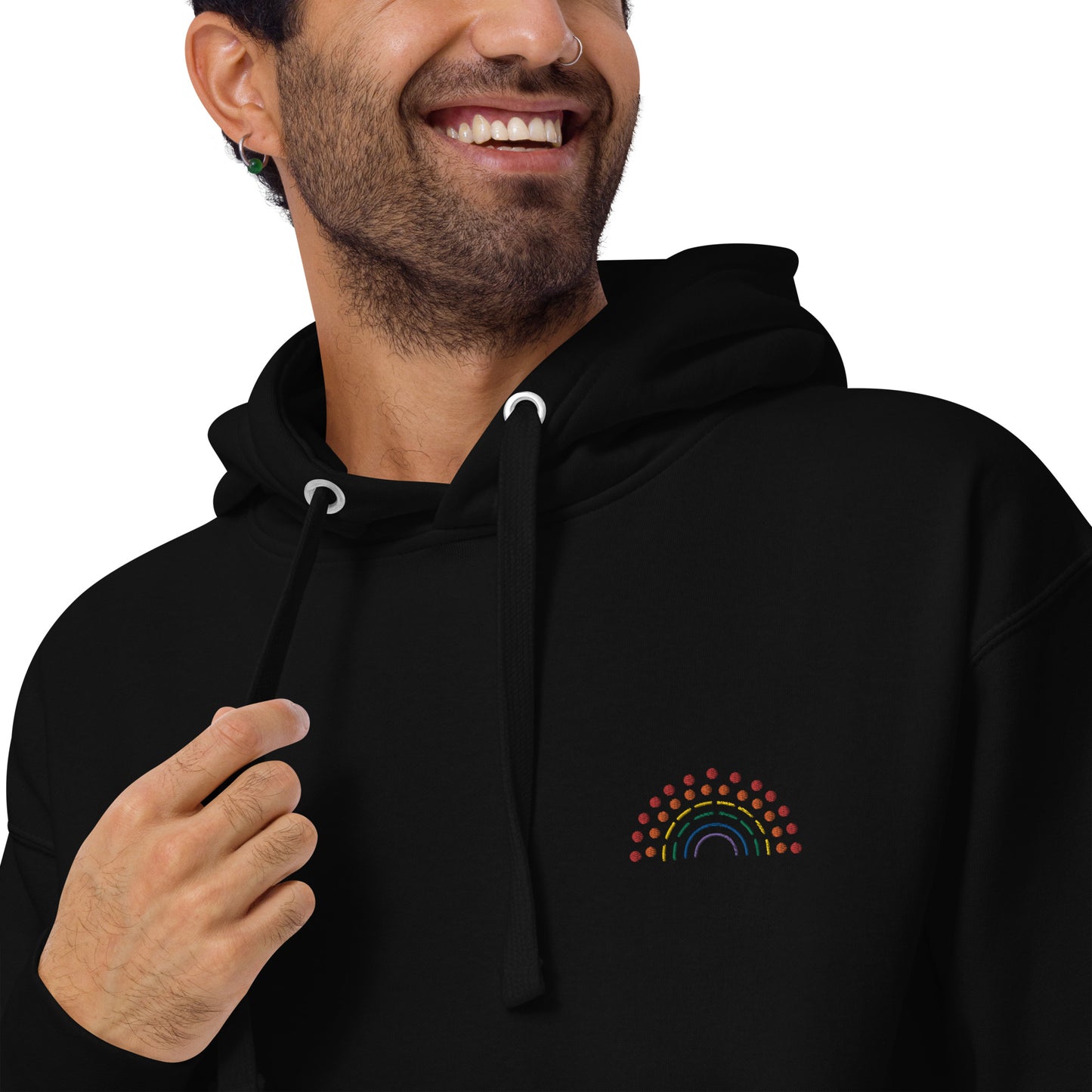 zoomed in image of person wearing a black hoodie sweatshirt with multicolored pride rainbow embroidered on the left chest