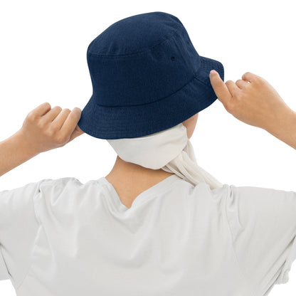 person wearing a dark blue denim bucket hat displaying the back of the hat