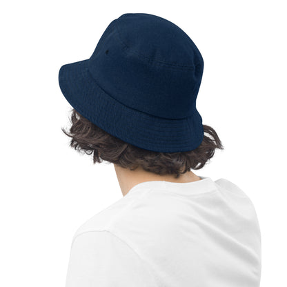 person wearing a dark blue denim bucket hat displaying the back of the hat