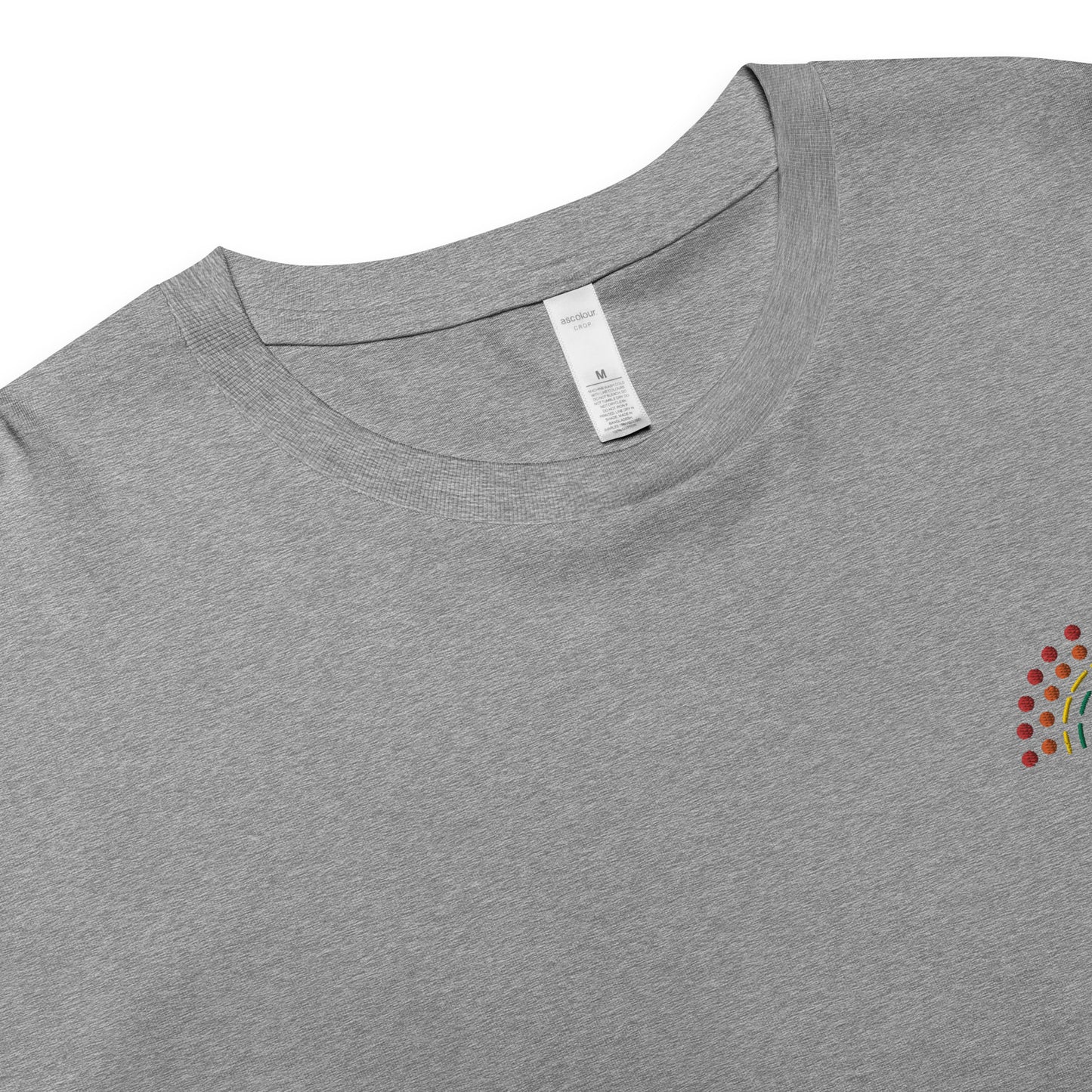 zoomed in image of grey crop top featuring inside label with logo and product details