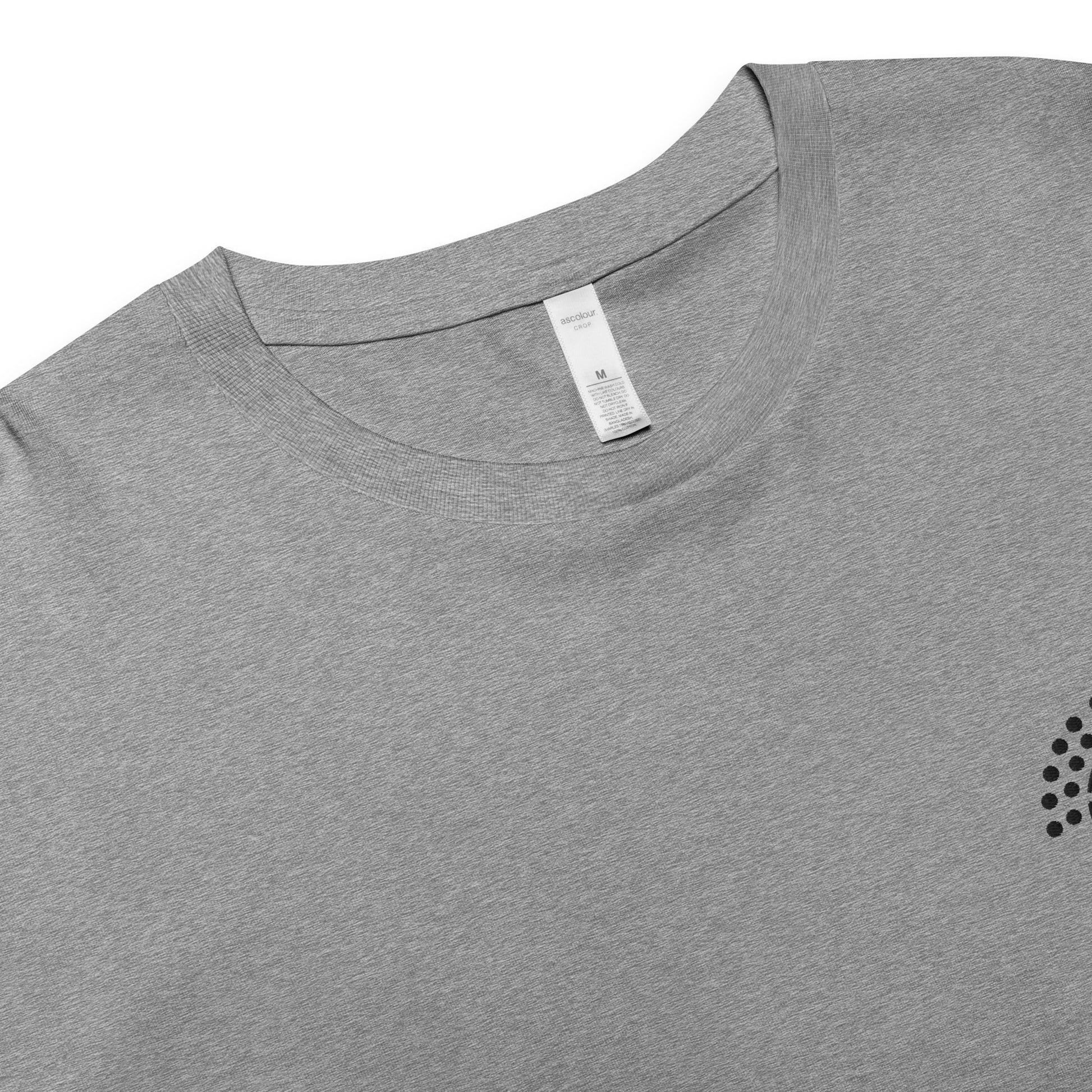 zoomed in image of grey crop top featuring inside label with logo and product details