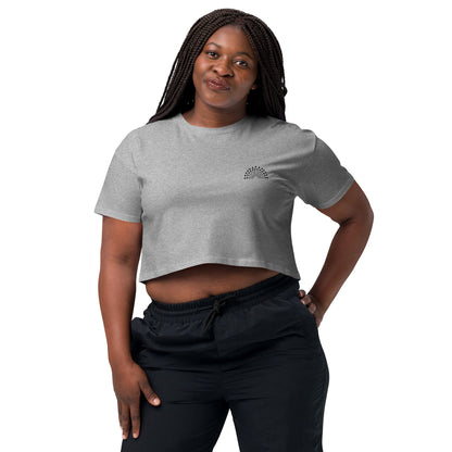 person wearing a grey crop top with black pride rainbow embroidered on the left chest