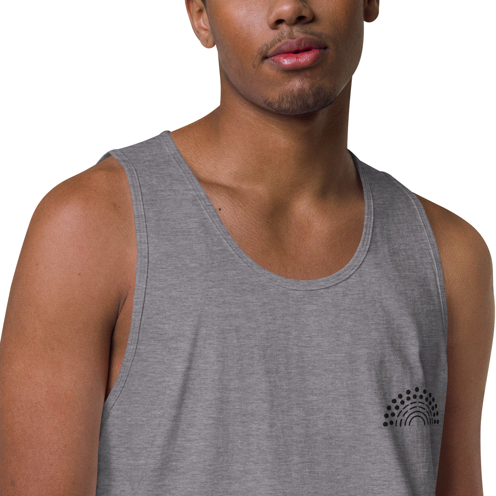 zoomed in image of person wearing a grey athletic tank top with black pride rainbow embroidered on the left chest