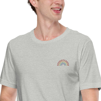 person wearing a grey t-shirt with multicolored pride rainbow embroidered on the left chest