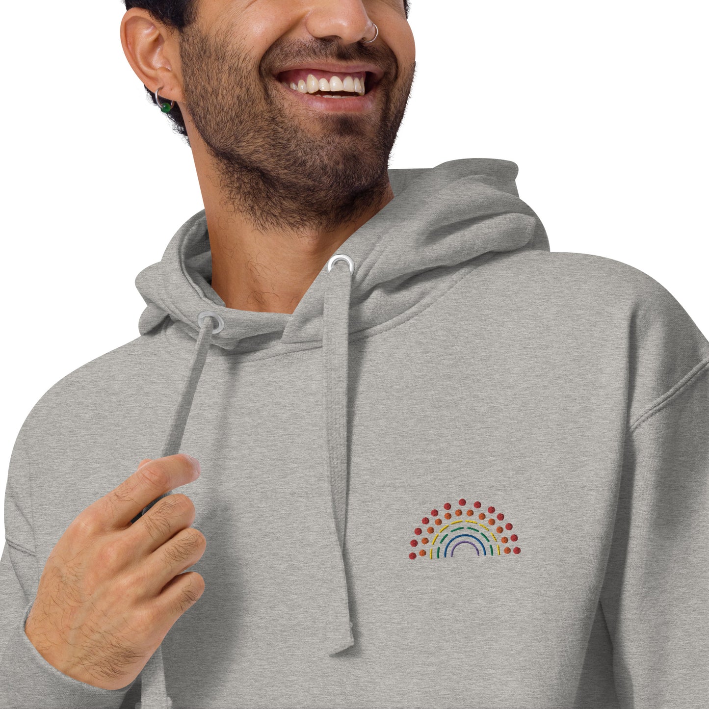 zoomed in image of person wearing a grey hoodie sweatshirt with multicolored pride rainbow embroidered on the left chest