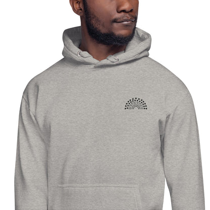 zoomed in image of person wearing a grey hoodie sweatshirt with black pride rainbow embroidered on the left chest