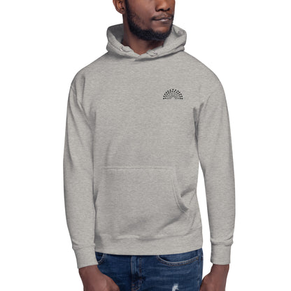 person wearing a grey hoodie sweatshirt with black pride rainbow embroidered on the left chest