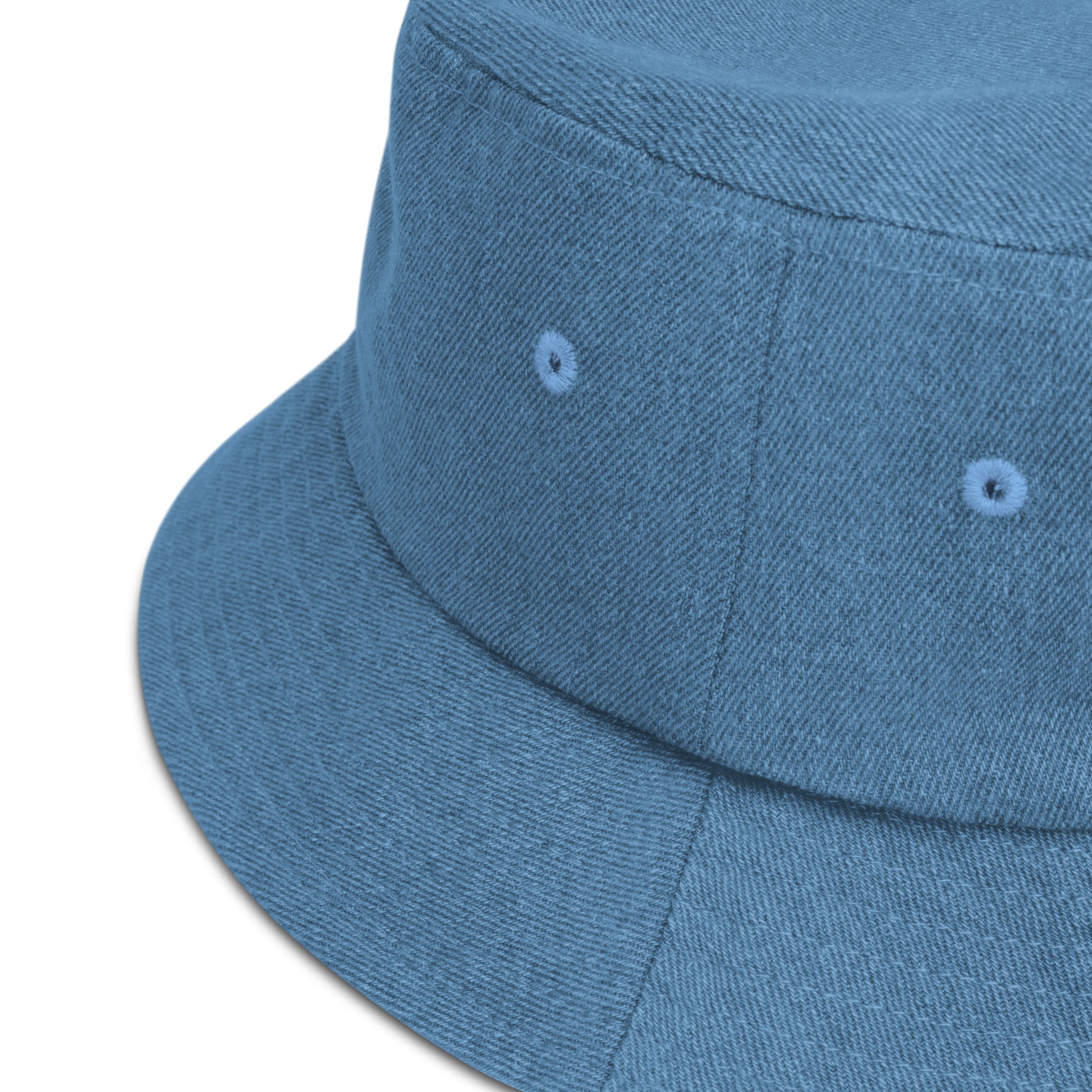 zoomed in image of light blue denim bucket hat showing detail of fabric