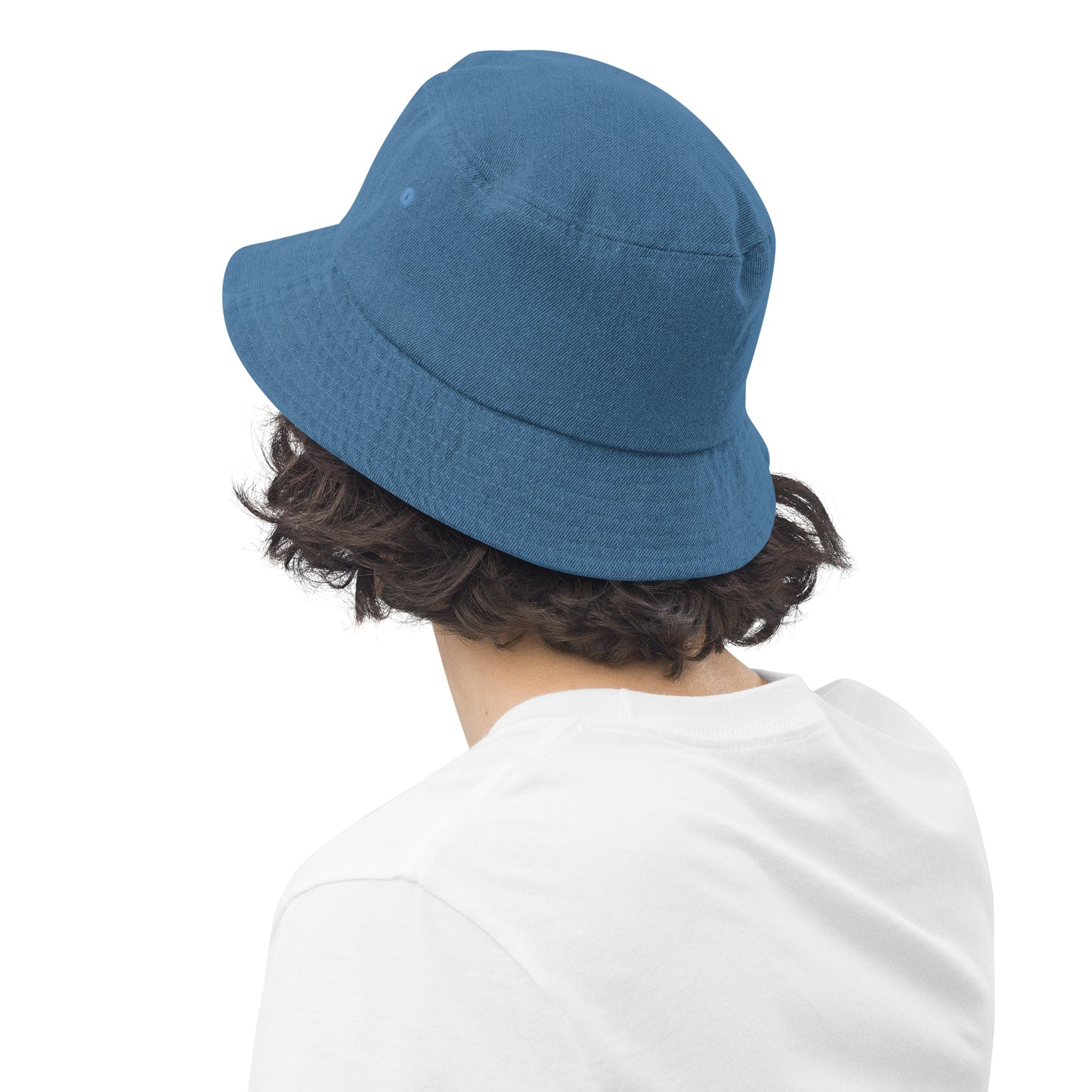 person wearing a light blue denim bucket hat displaying the back of the hat