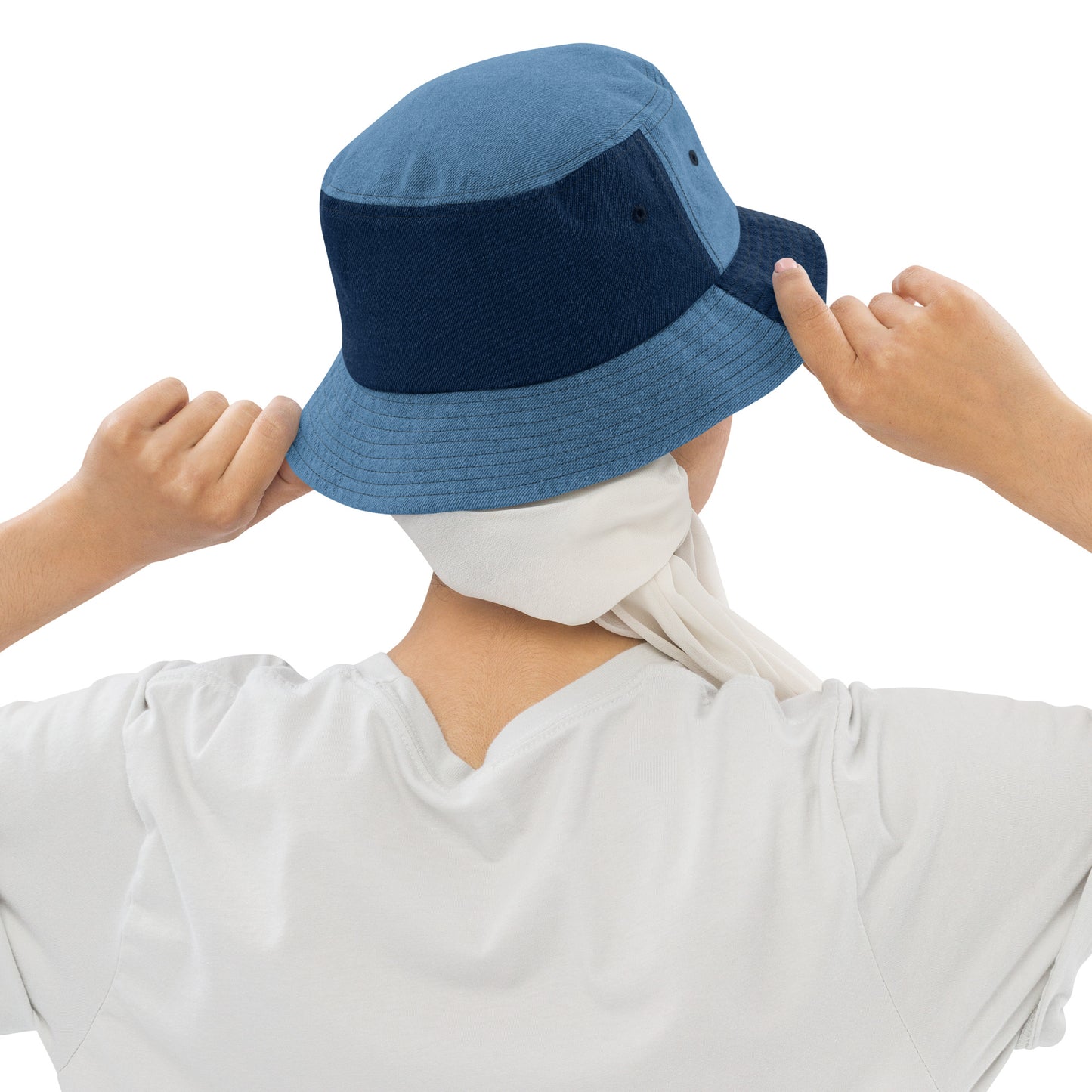 person wearing a mixed denim bucket hat displaying the back of the hat