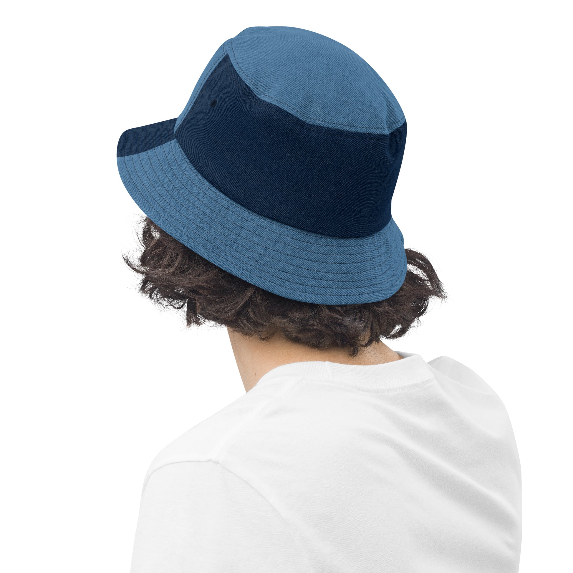 person wearing a mixed denim bucket hat displaying the back of the hat