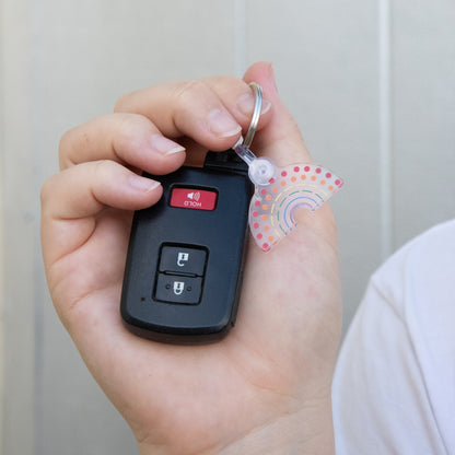 Zoomed in image of car keys and multicolored pride keychain