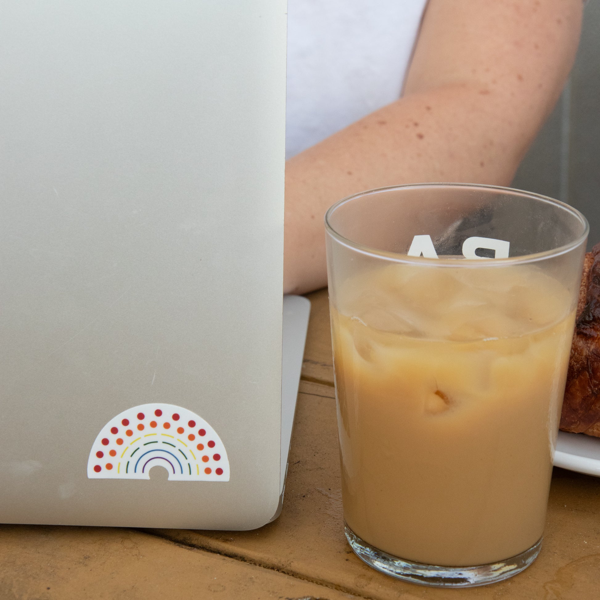 Zoomed in image of a laptop with a multicolored pride sticker