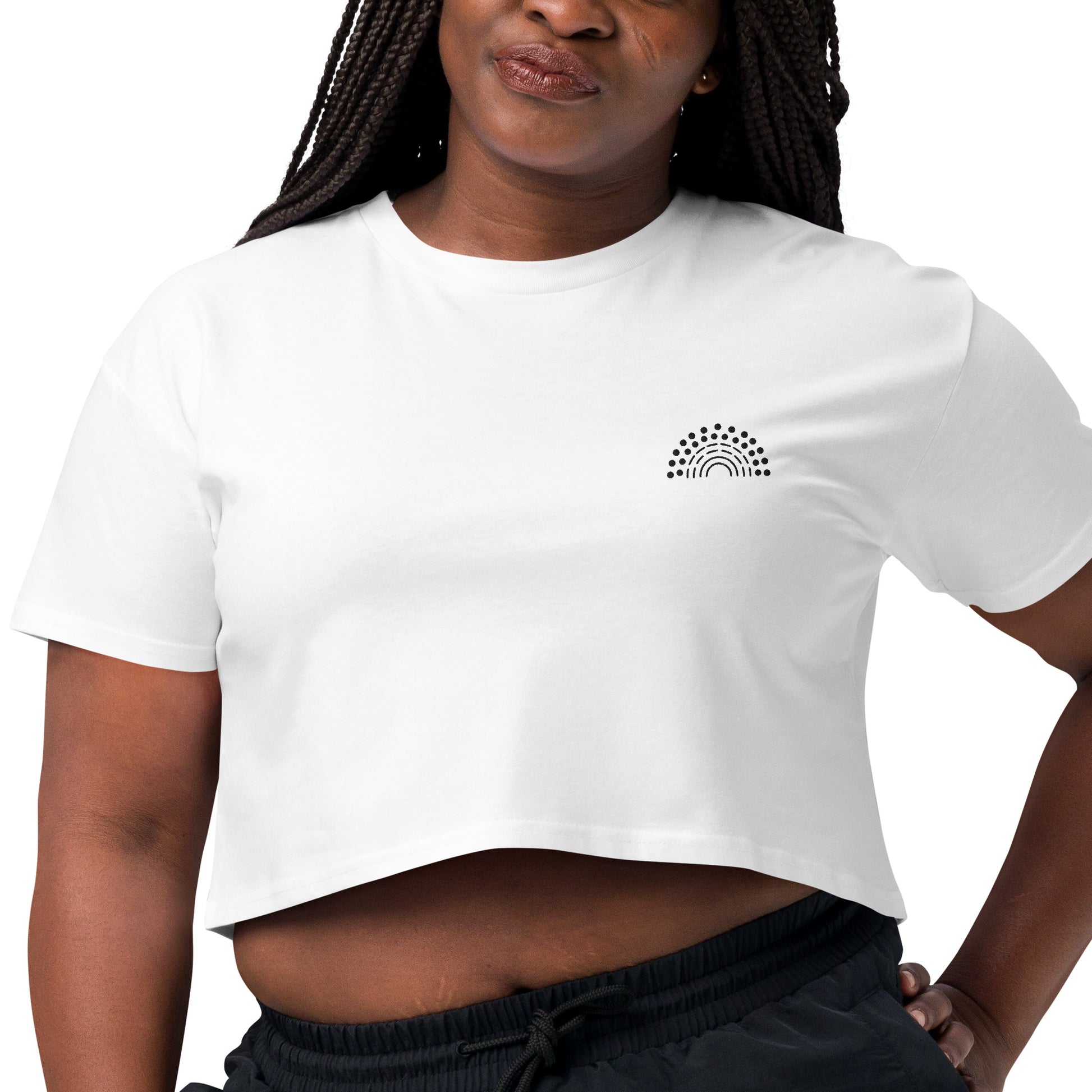 zoomed in image of person wearing a white crop top with black pride rainbow embroidered on the left chest