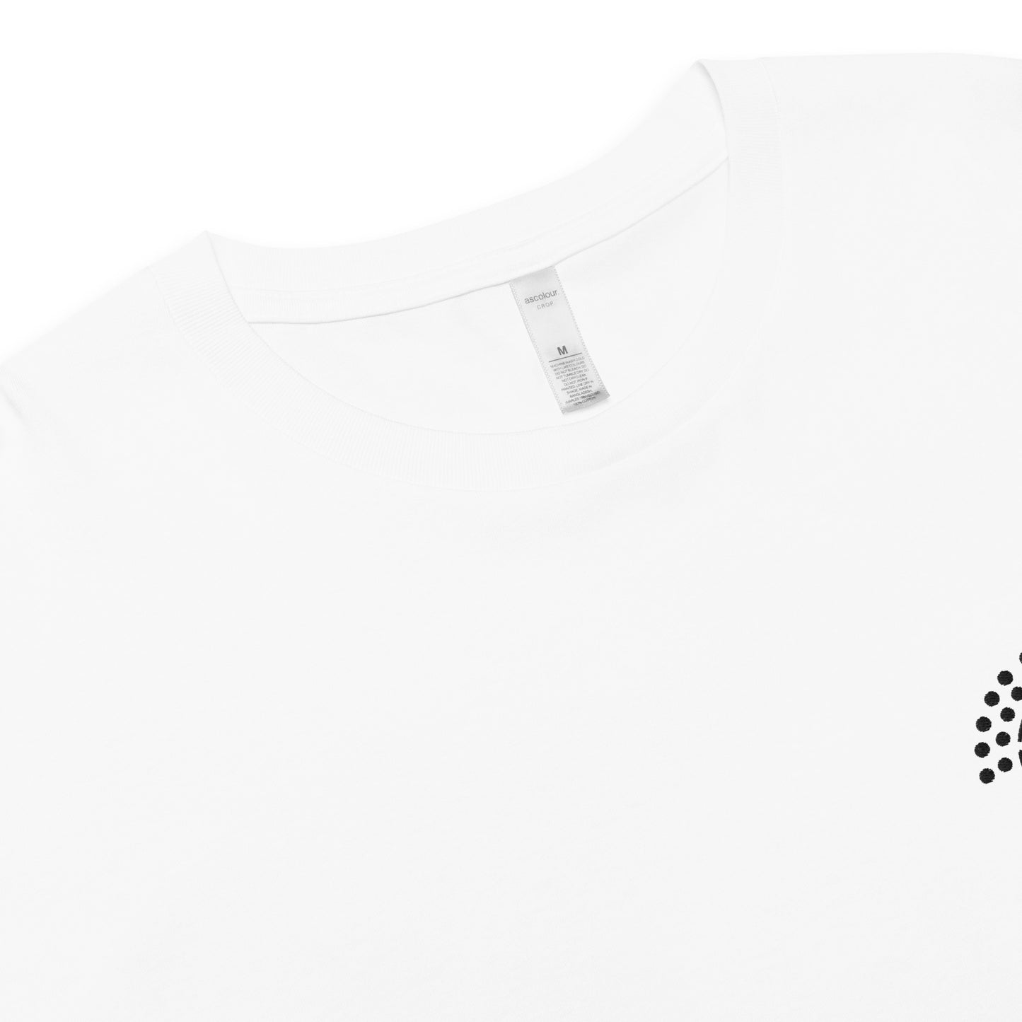 zoomed in image of white crop top featuring inside label with logo and product details