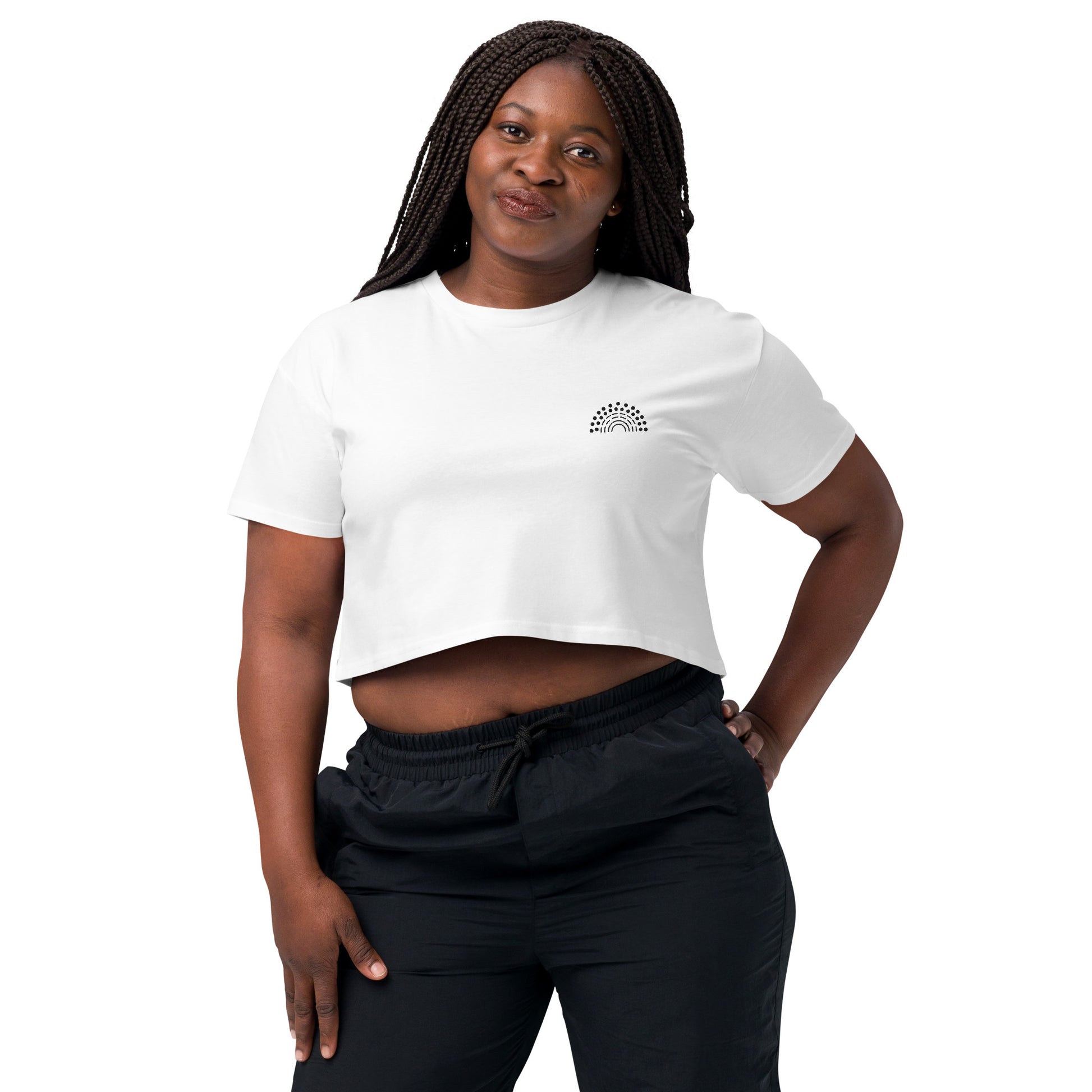 person wearing a white crop top with black pride rainbow embroidered on the left chest