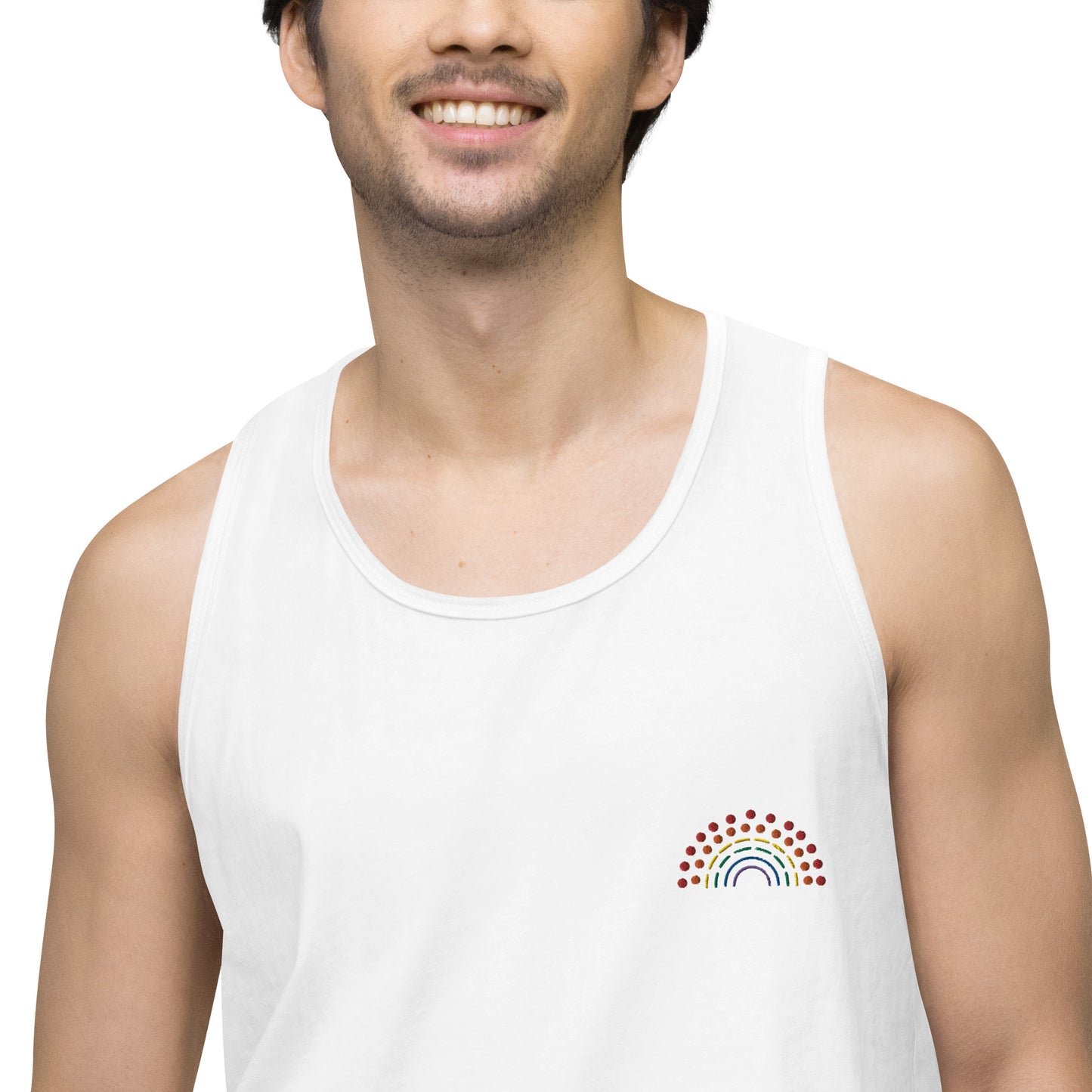 zoomed in image of person wearing a white athletic tank top with multicolored pride rainbow embroidered on the left chest