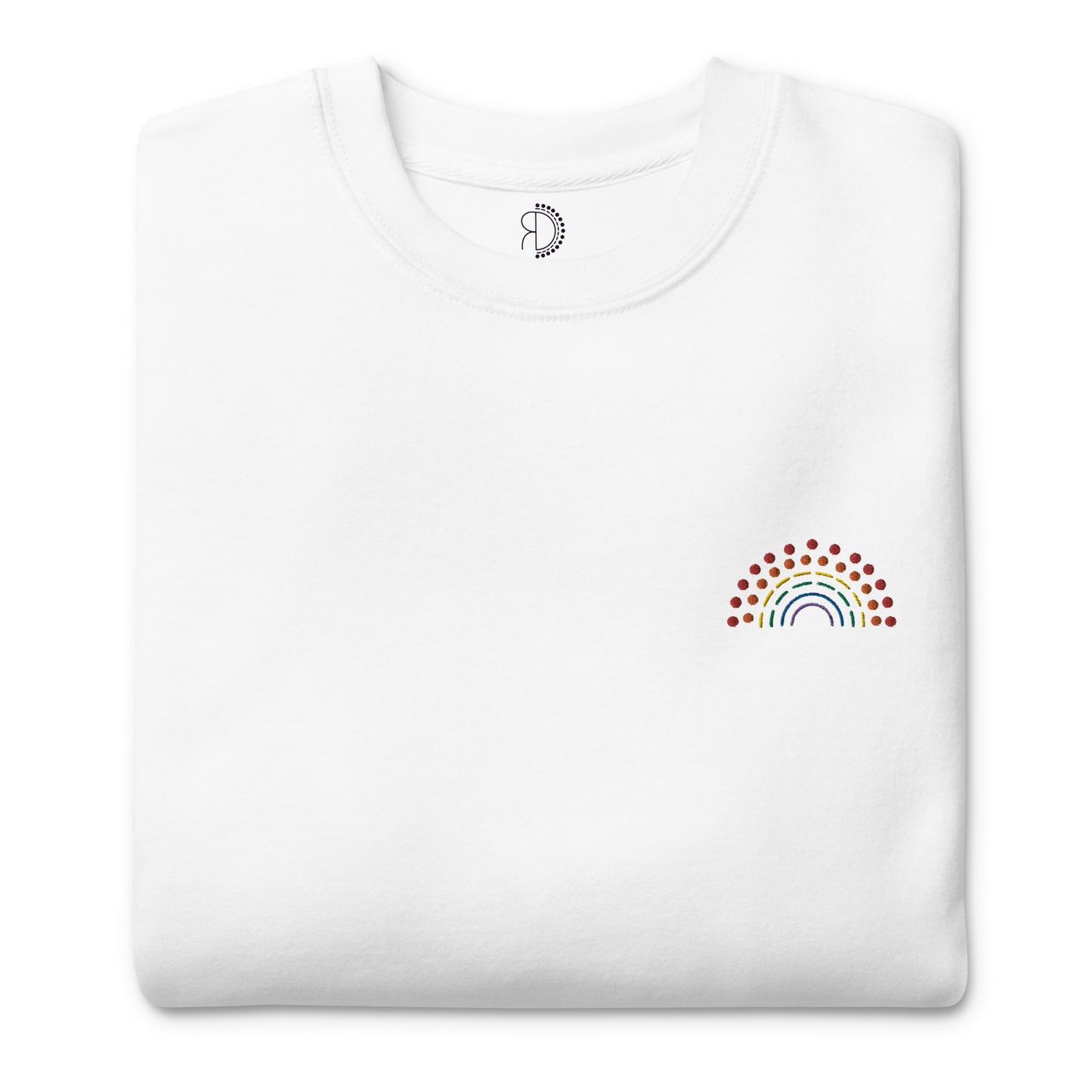 folded white crewneck sweatshirt with multicolored pride rainbow embroidered on the left chest and an inside label featuring logo