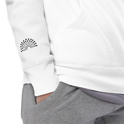 zoomed in image of person wearing a white crewneck sweatshirt with black pride rainbow embroidered on the right wrist