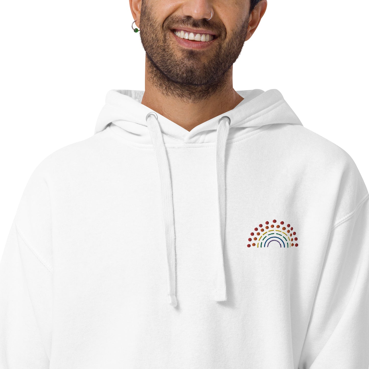 person wearing a white hoodie sweatshirt with multicolored pride rainbow embroidered on the left chest