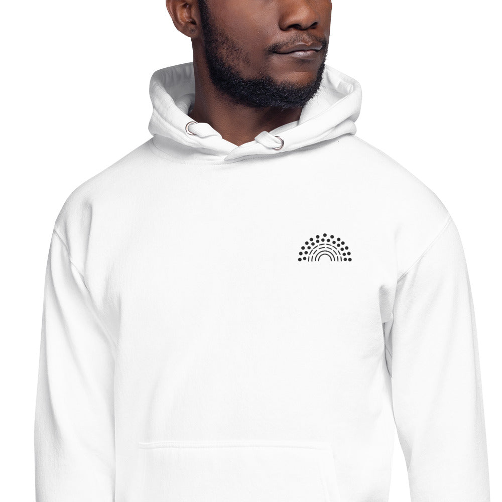 zoomed in image of person wearing a white hoodie sweatshirt with black pride rainbow embroidered on the left chest